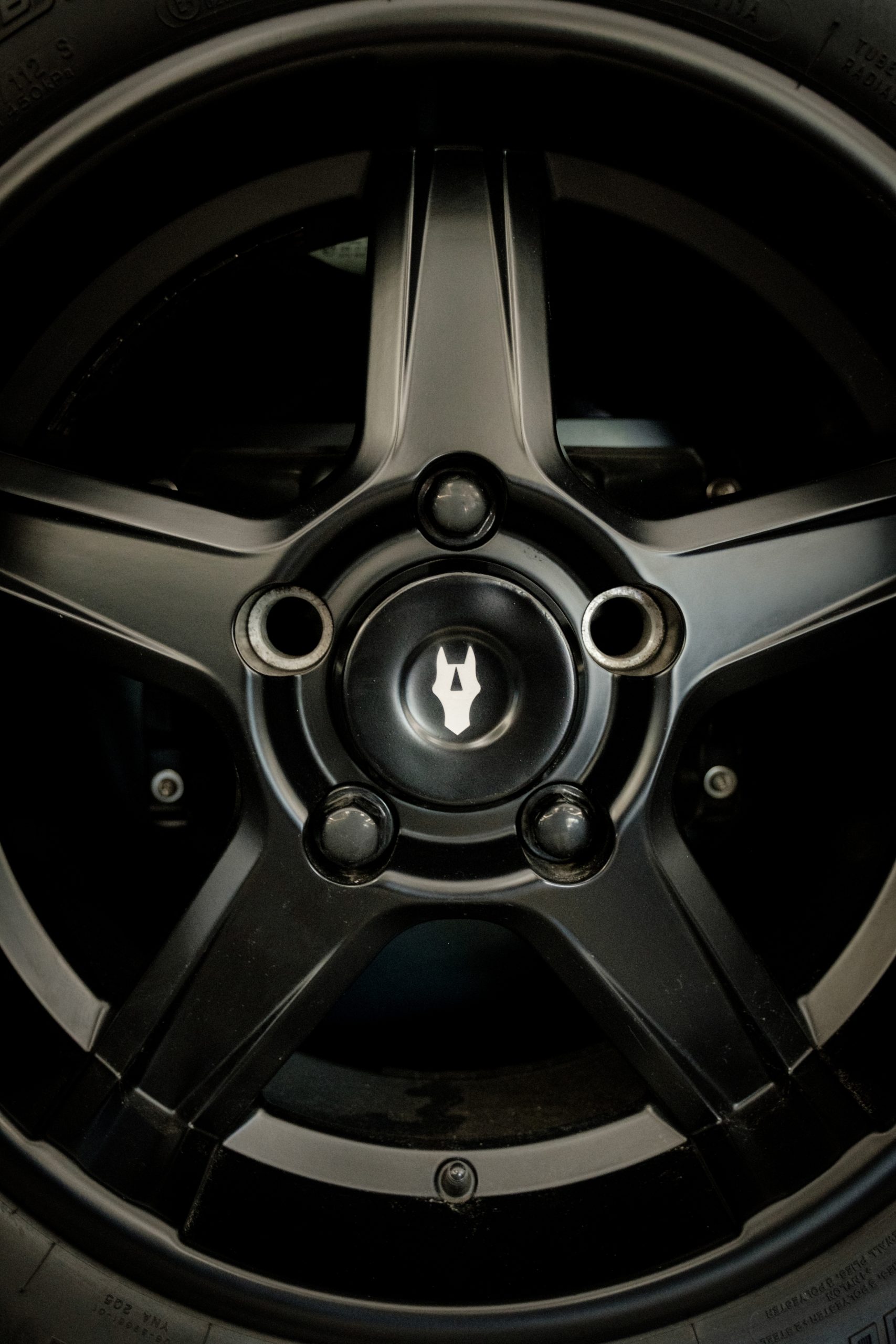 Black alloy wheel with the Autelier crest centre cap