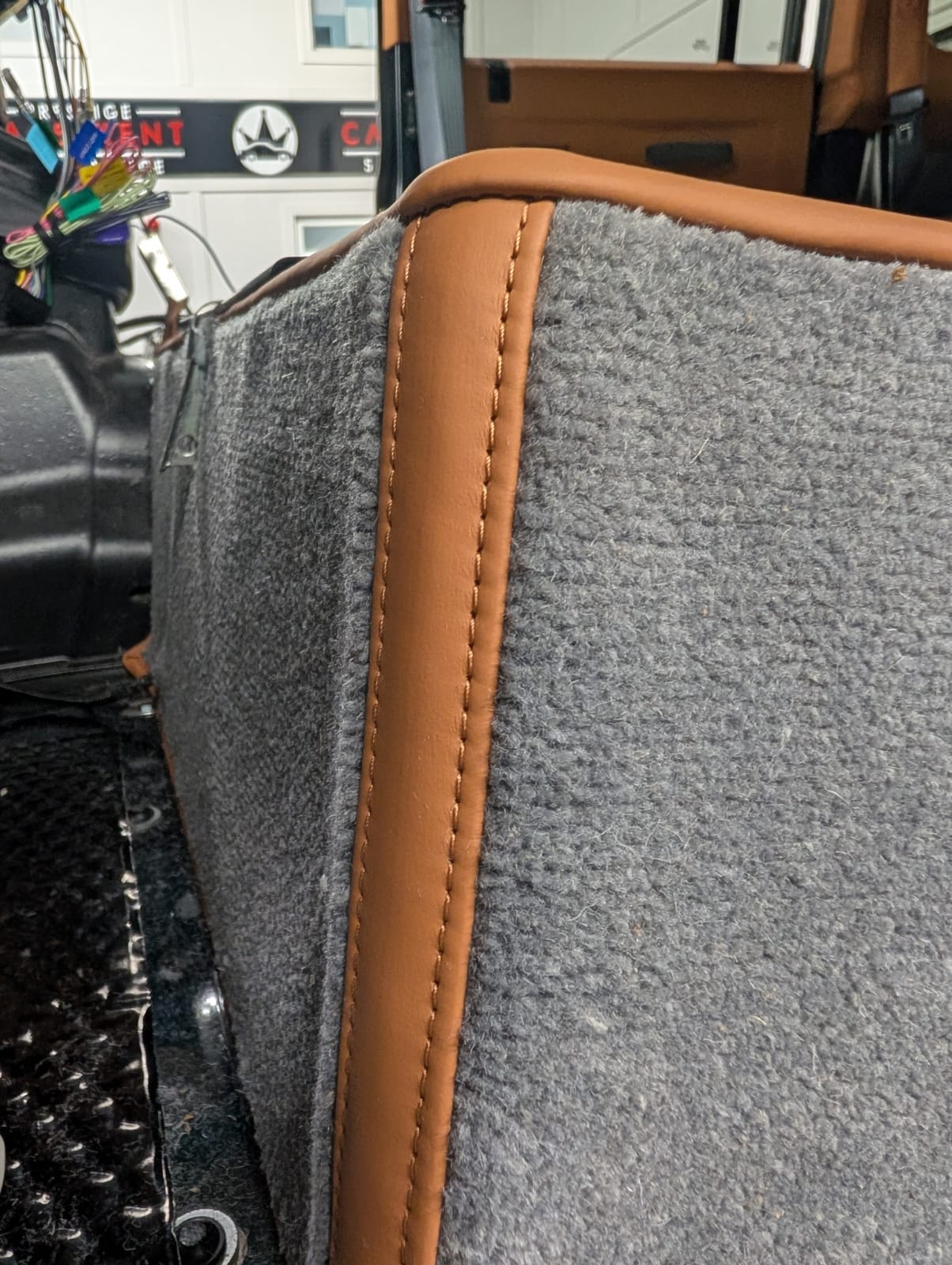 Hand-stitched leather trim being fitted to a Defender interior