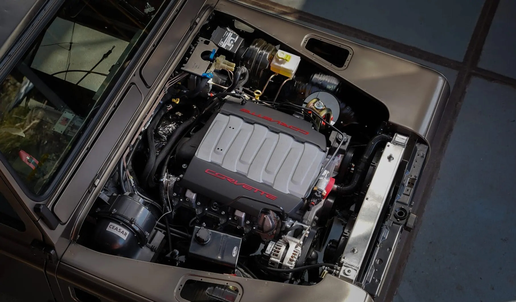 An engine being lowered into a Defender chassis