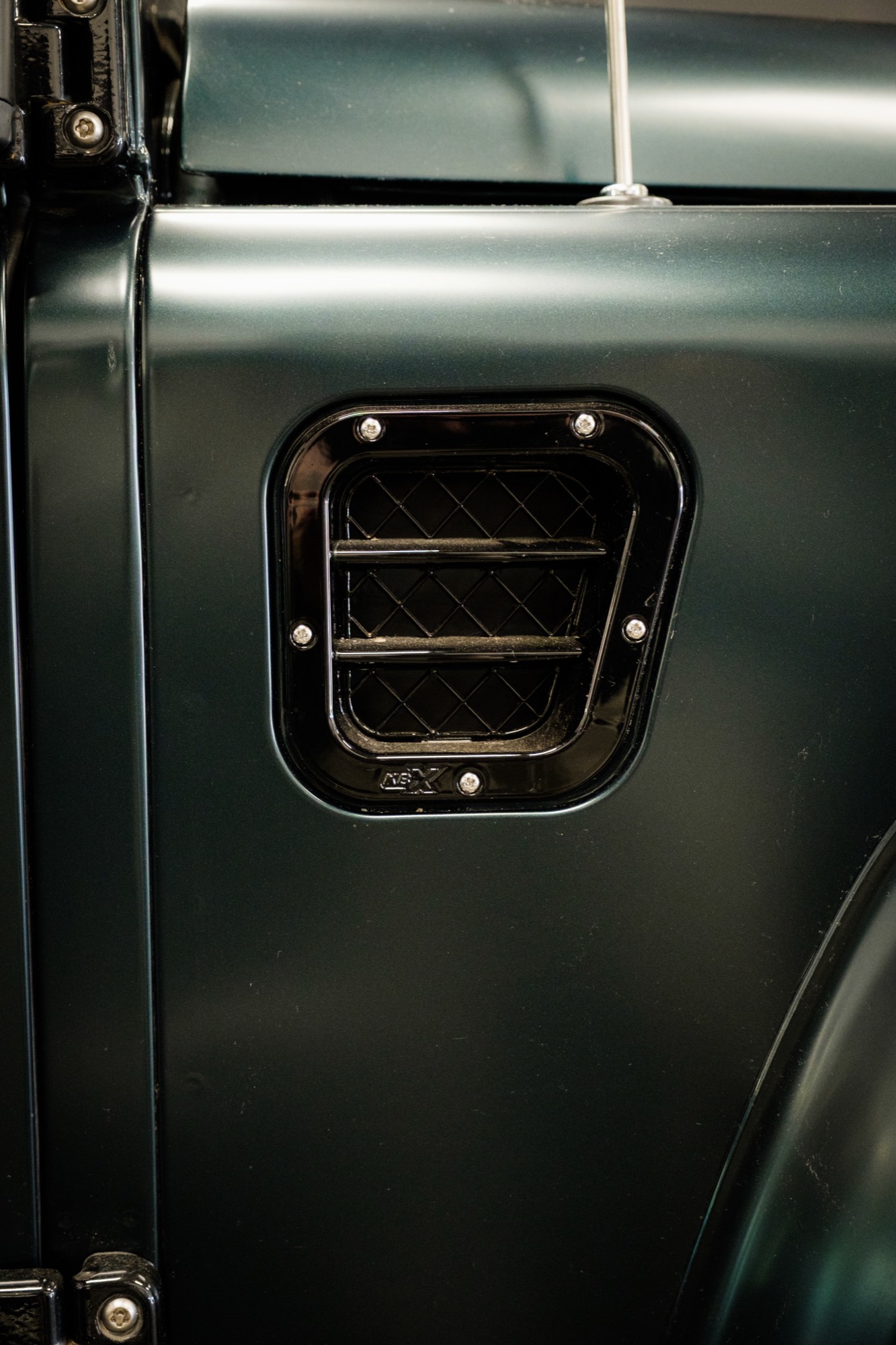 Side air-intake vent set into the dark green wing
