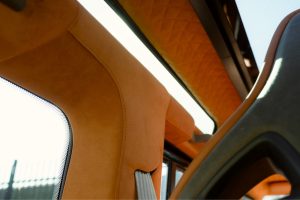 Quilted tan leather headlining and cabin pillars