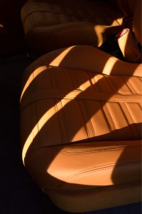 Sunlight across a quilted tan leather seat