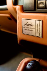 Autelier build plaque stitched into the tan leather dashboard