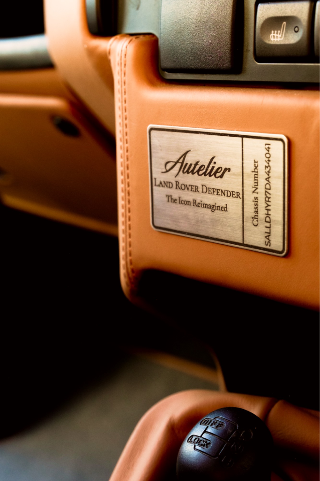 Autelier build plaque stitched into the tan leather dashboard